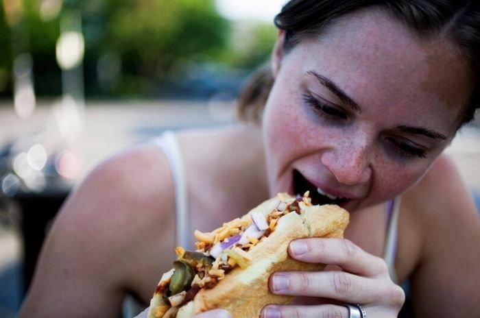 girl eating hot dog