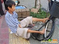 TopRq.com search results: Armless guy can fix your bike, China