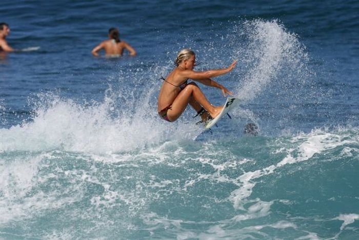 young surfing girl