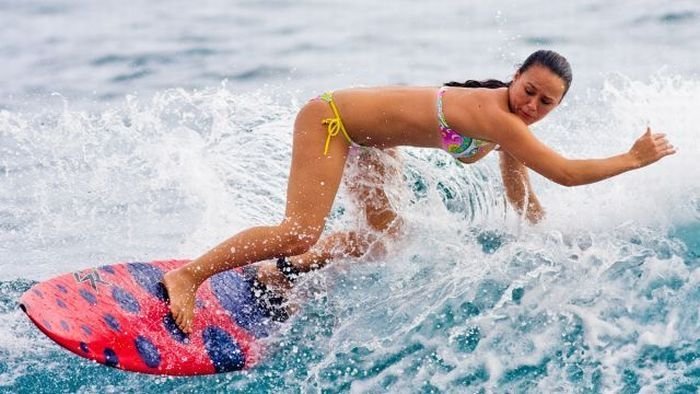 young surfing girl