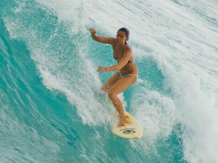 young surfing girl