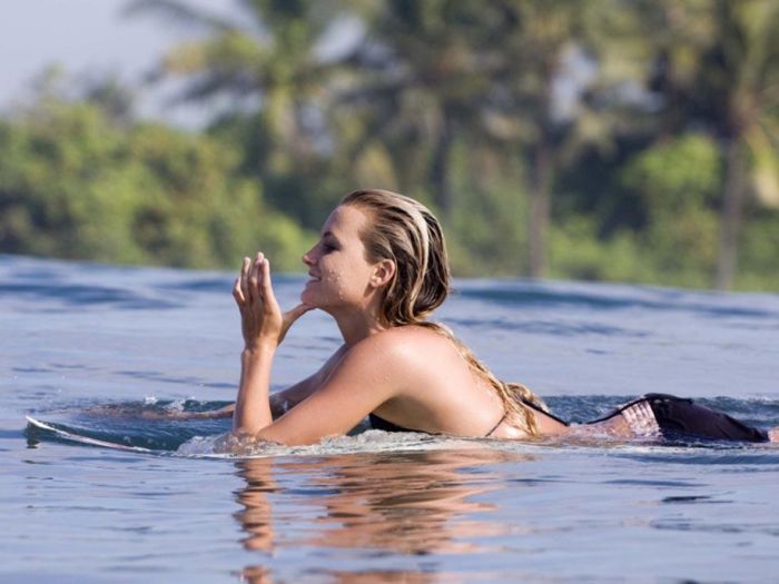 young surfing girl