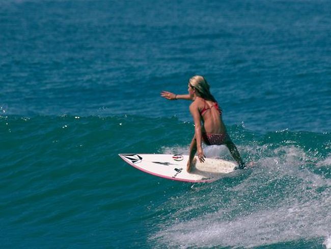 young surfing girl