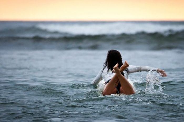 young surfing girl