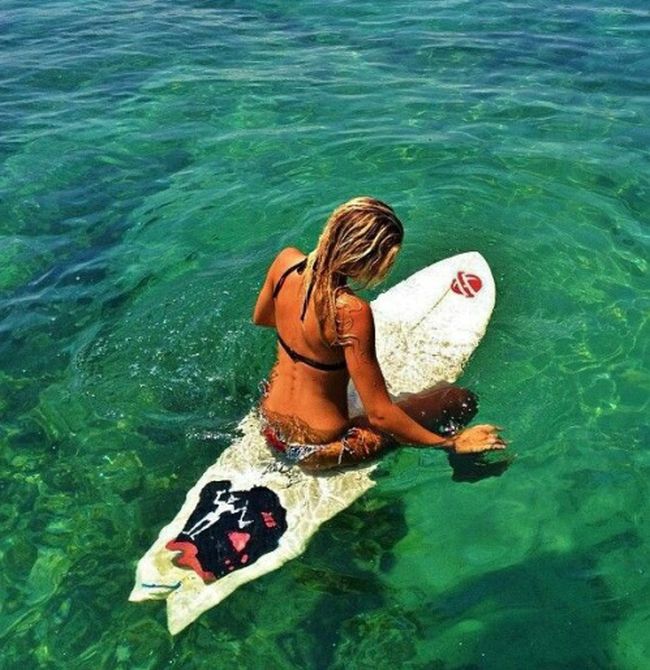 young surfing girl