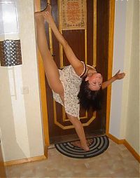 Sport and Fitness: young brunette girl doing flexible gymnastics at home